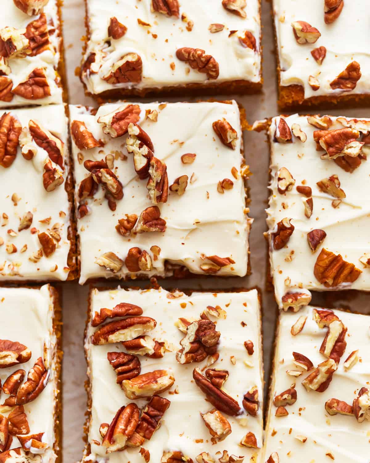 Pumpkin squares topped with cream cheese frosting and pecans.