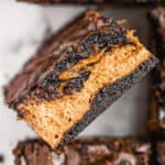 A stack of halloween brownies with peanut butter filling.