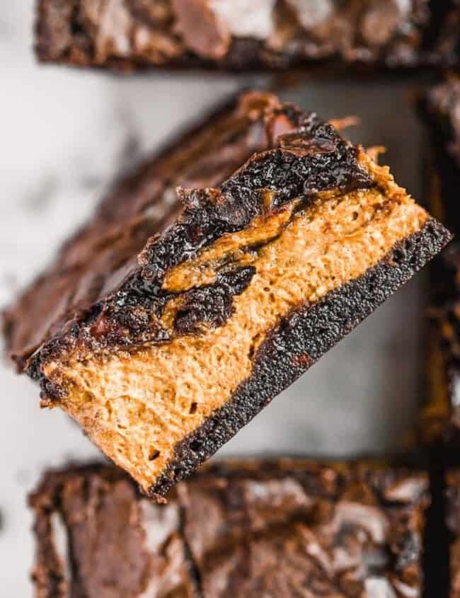 A stack of halloween brownies with peanut butter filling.