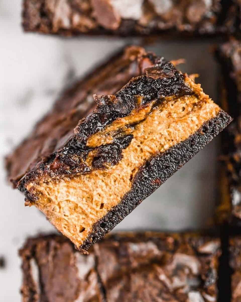 A stack of halloween brownies with peanut butter filling.