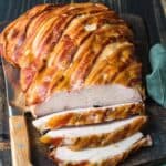 bacon wrapped turkey breast on cutting board