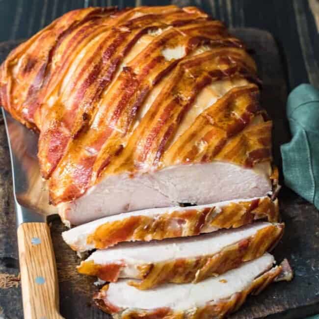 bacon wrapped turkey breast on cutting board