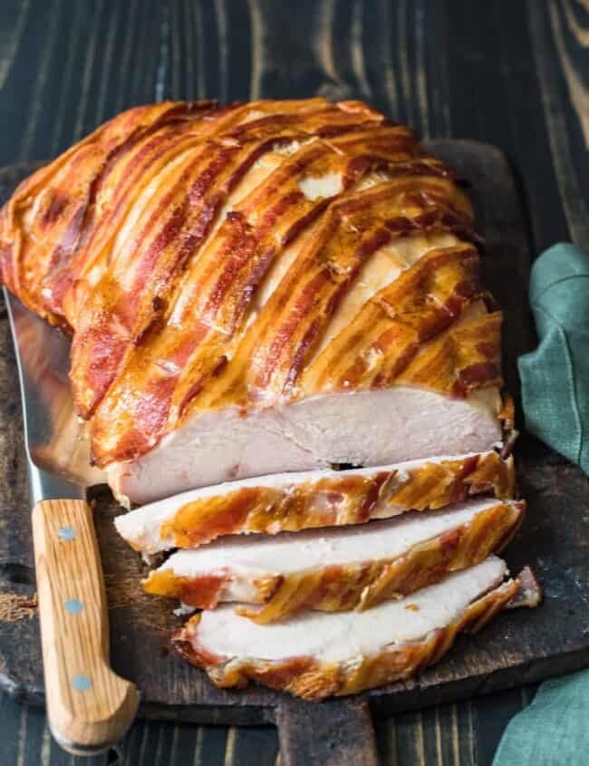 bacon wrapped turkey breast on cutting board