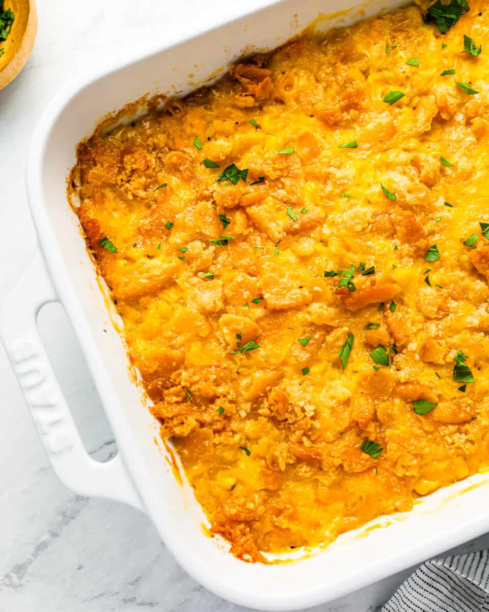 Close up on a casserole with cheese and cracker topping.