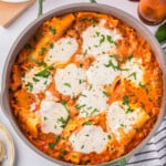 Lasagna in a pan with parmesan cheese on top.