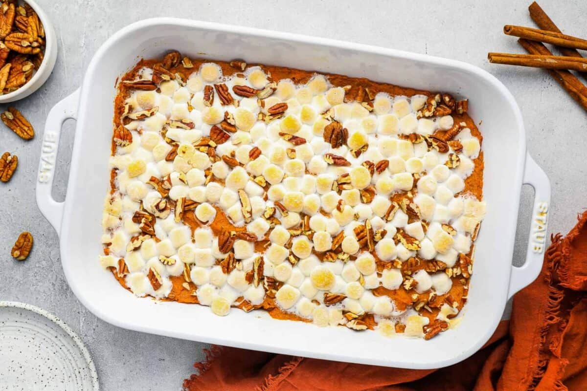 overhead view of baked sweet potato casserole in a white rectangular baking dish.