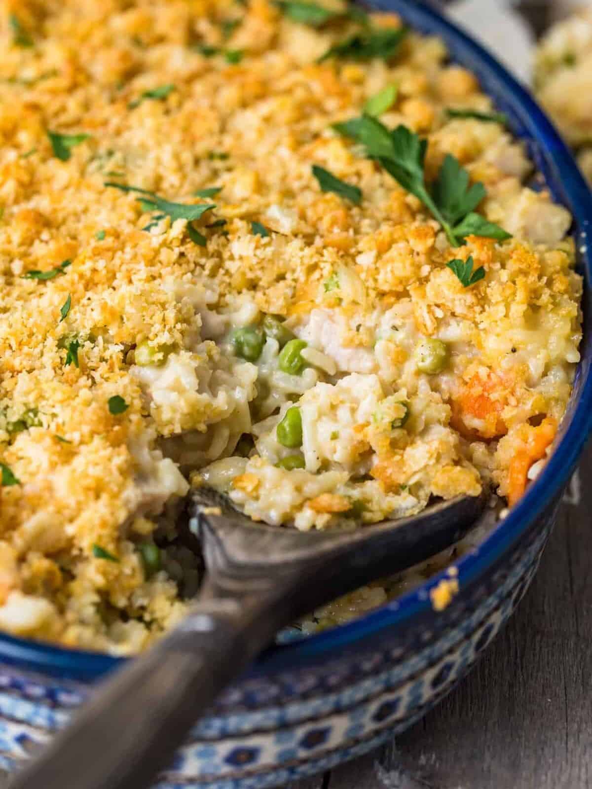 Turkey Rice Casserole in a blue casserole dish with a wooden spoon