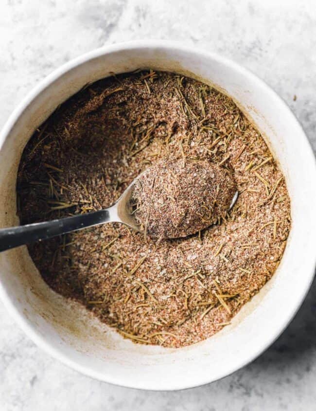 turkey rub in a white bowl with a spoon.