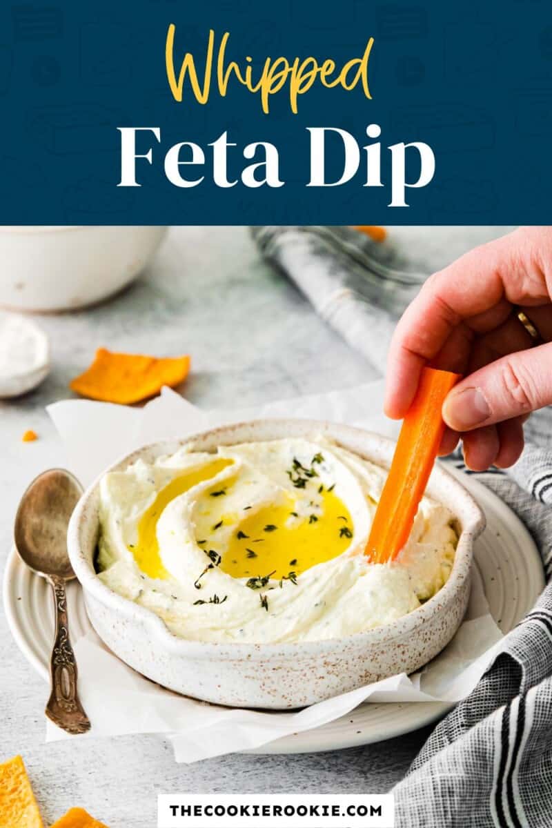 A bowl of whipped feta dip with a carrot in it.