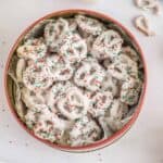 christmas pretzels in a bowl with sprinkles.