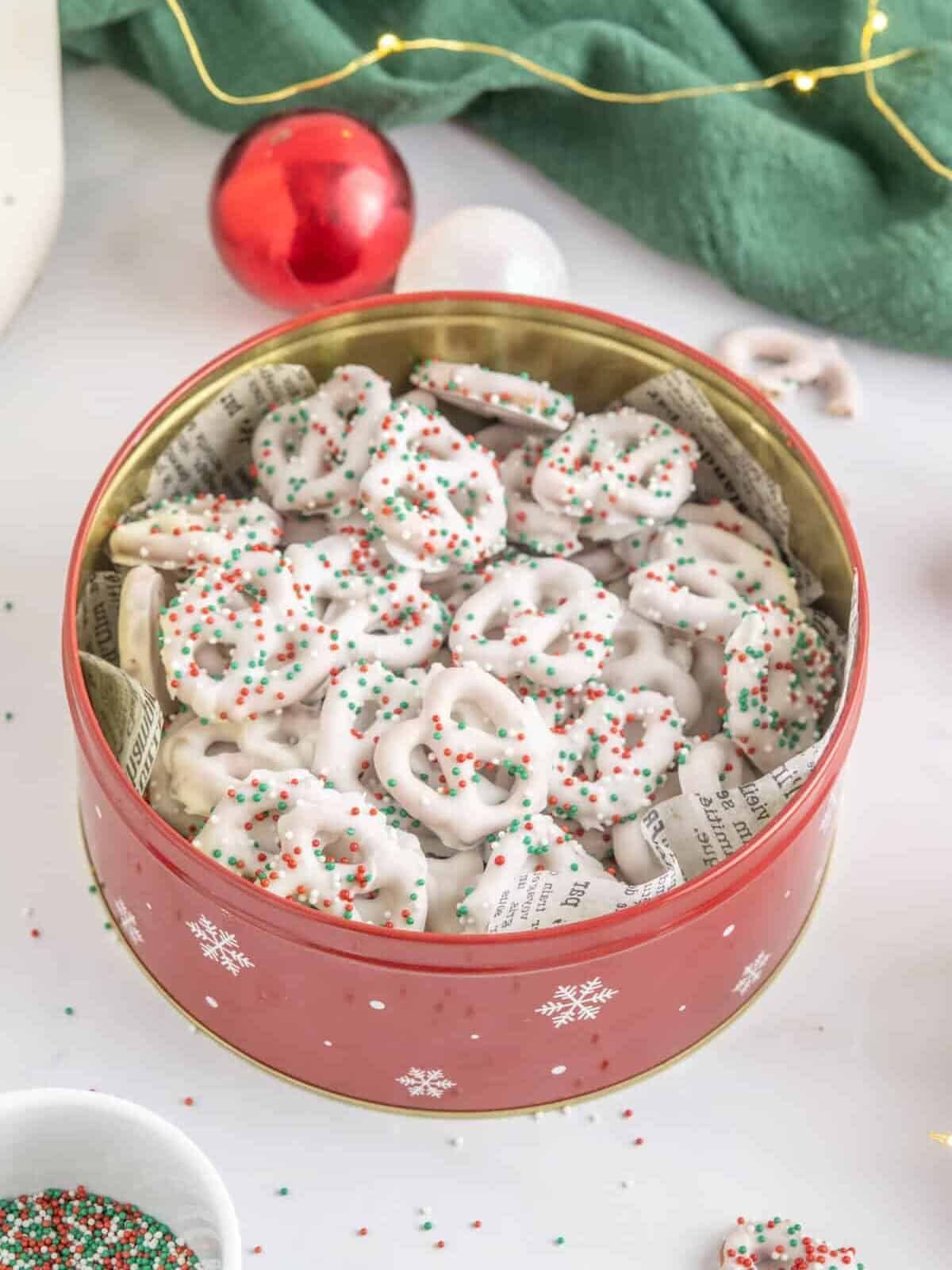 christmas pretzels in a tin with sprinkles.