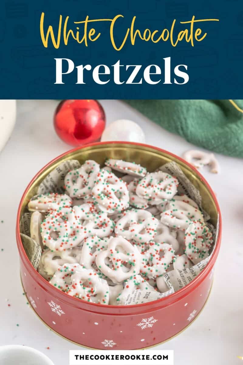 White chocolate pretzels in a tin with christmas decorations.