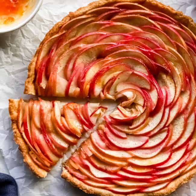 A slice of apple tart on a piece of paper.