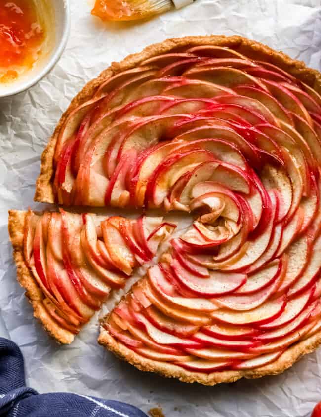 A slice of apple tart on a piece of paper.