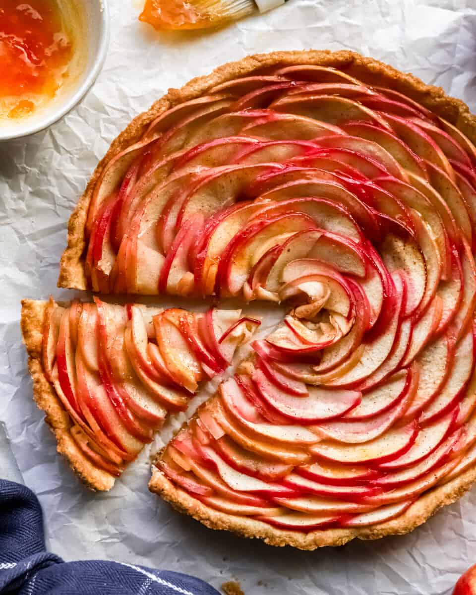 A slice of apple tart on a piece of paper.