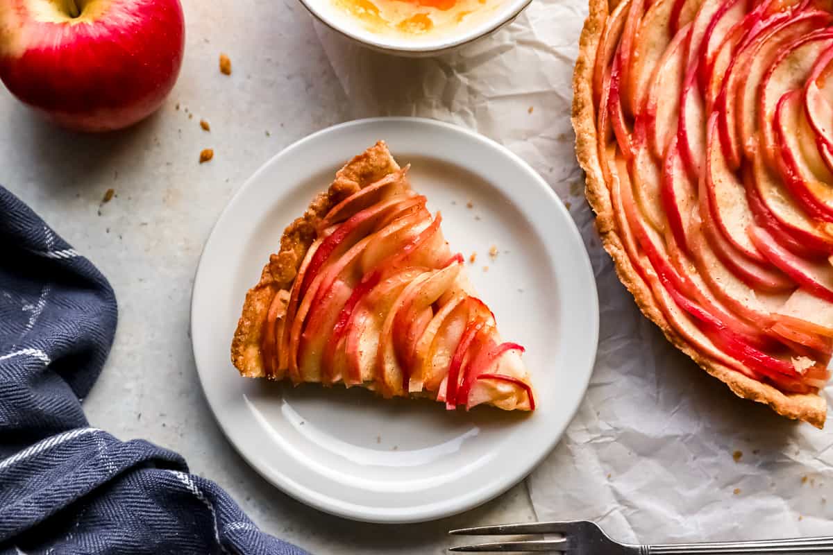 A slice of apple tart on a plate.