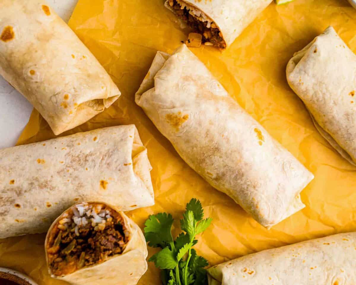 beef and bean burritos on parchment paper.