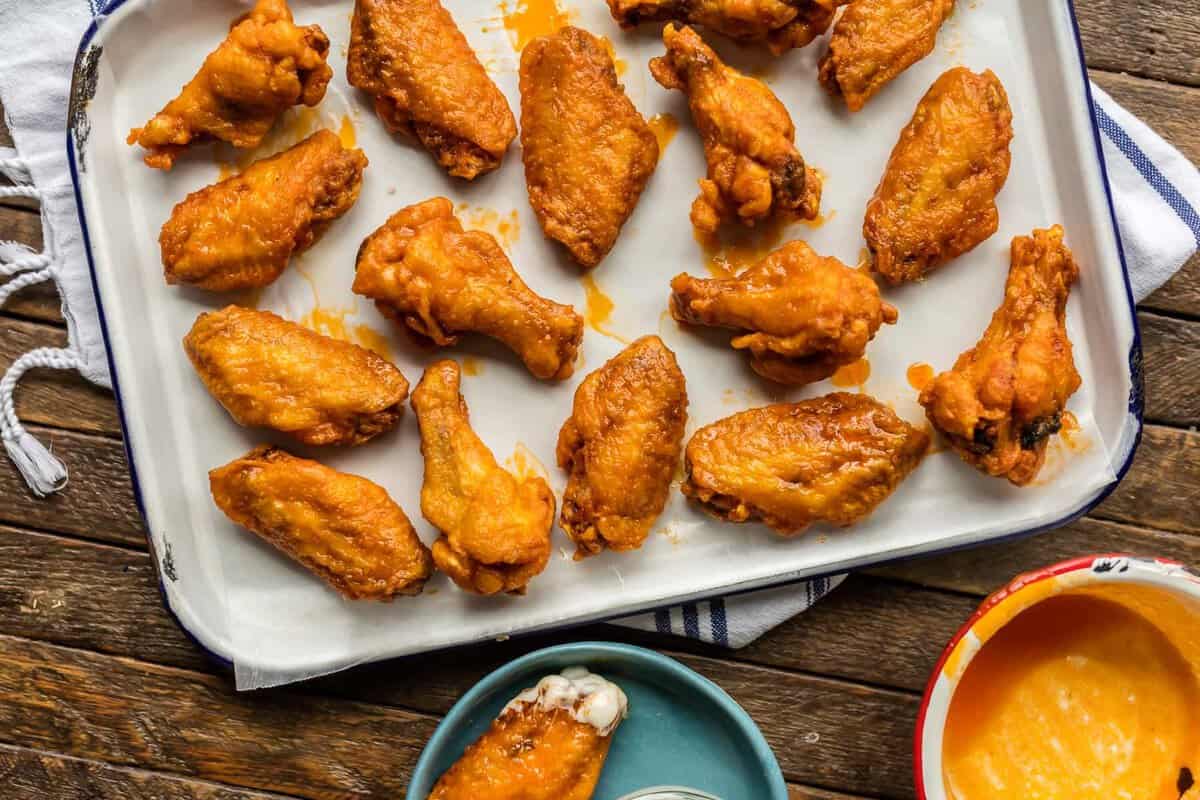 Gluten free fried buffalo wings on a baking tray