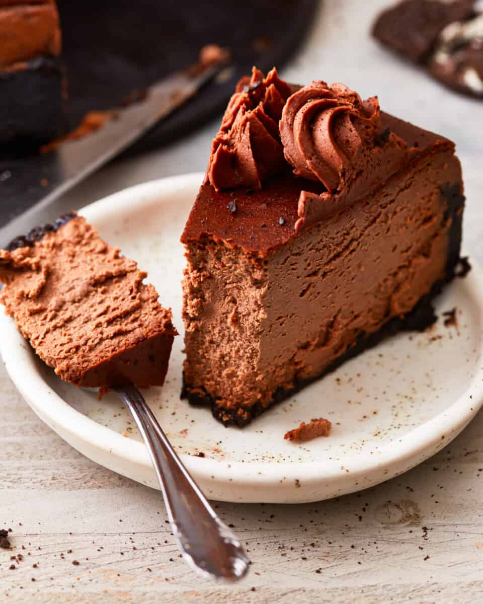 A slice of chocolate cheesecake on a plate.