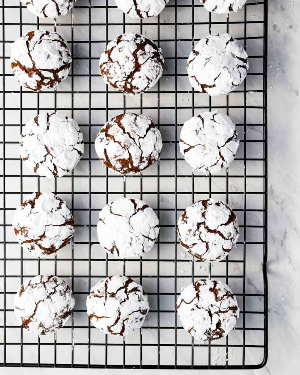 Chocolate crinkle cookies on a cooling rack.