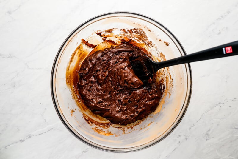Chocolate batter in a bowl with a spatula.