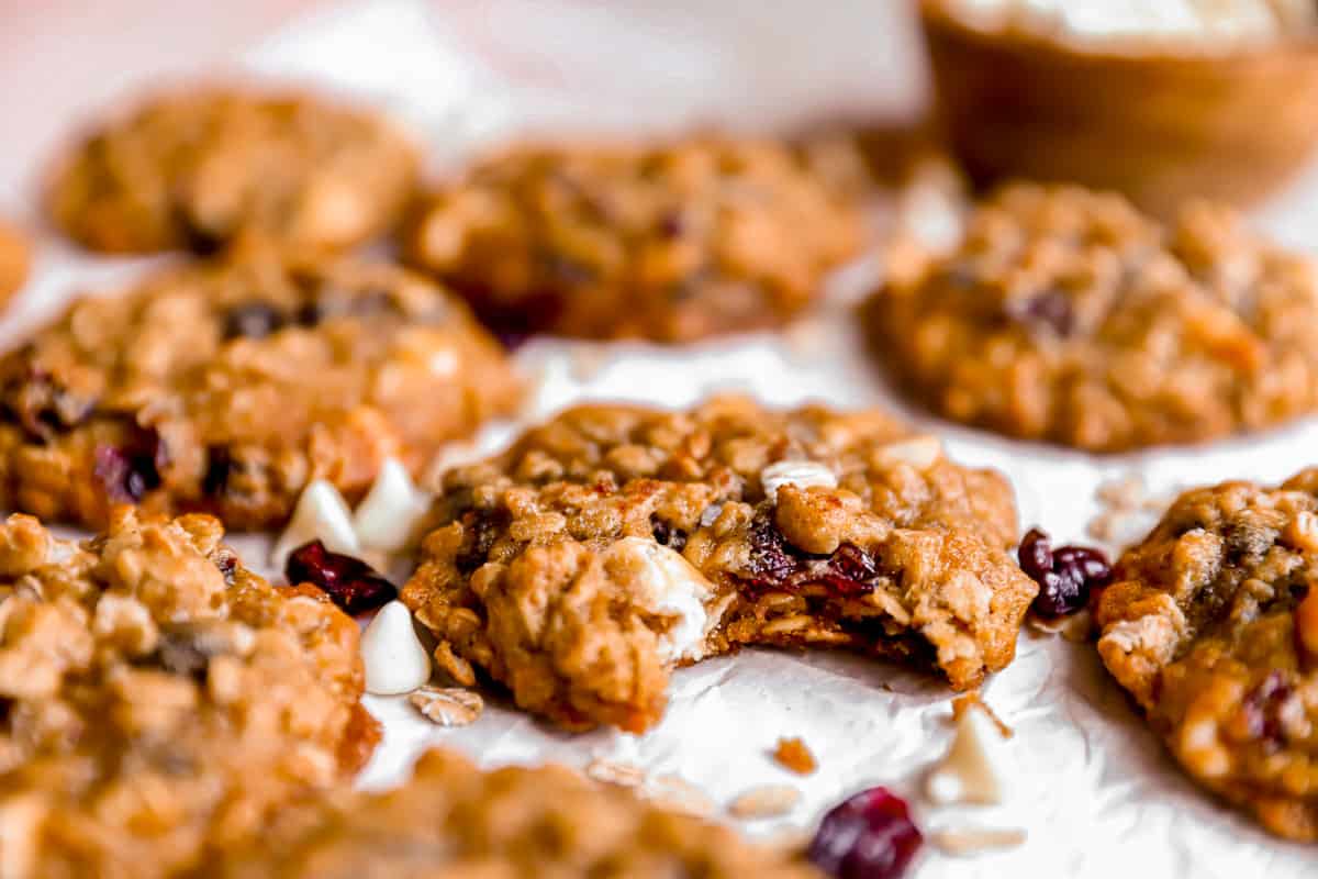 A cranberry oatmeal cookie with a bite missing.
