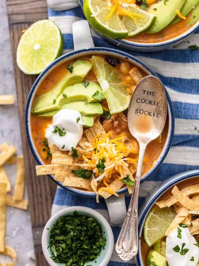 Bowls of chicken tortilla soup on a blue and white striped dish towel
