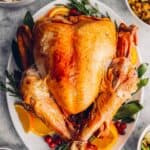 overhead view of deep fried turkey on a white serving plate.