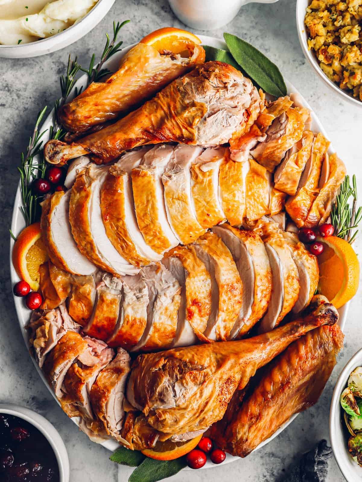 sliced deep fried turkey on a white serving plate.