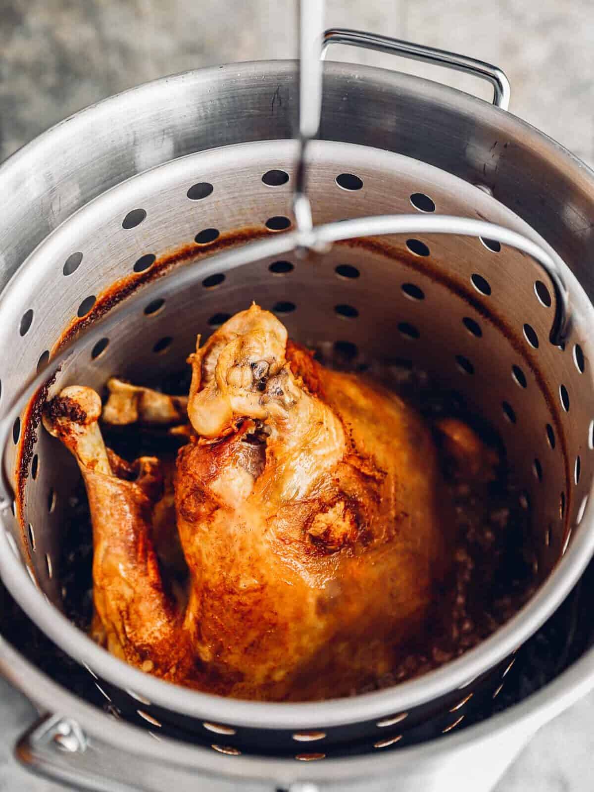 deep fried turkey in a strainer basket.