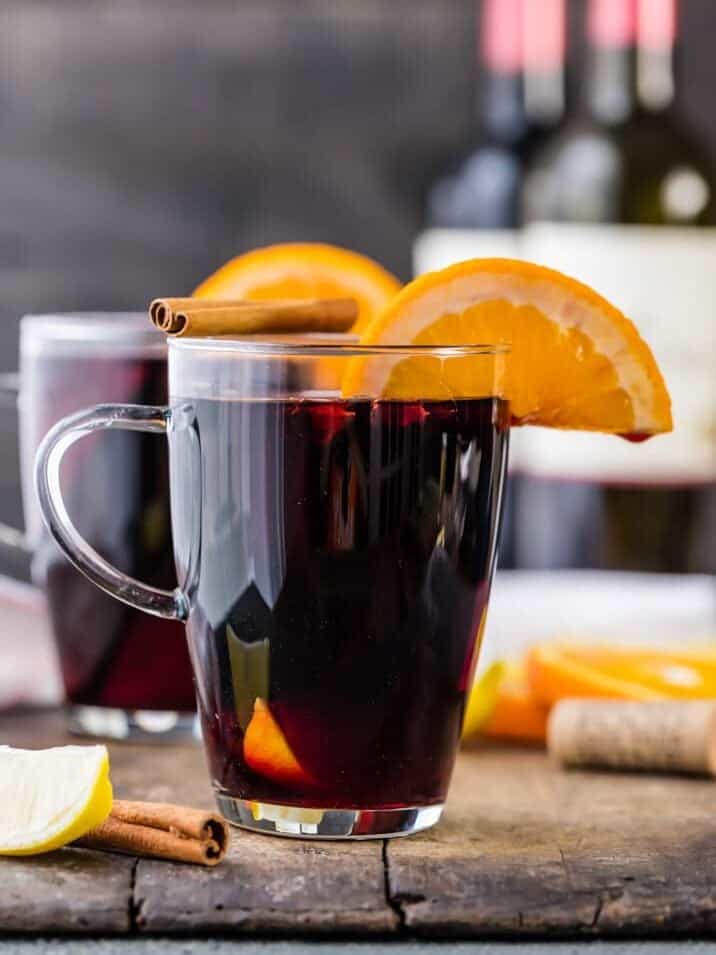 Glass of spiced wine with an orange slice and cinnamon stick sitting on top