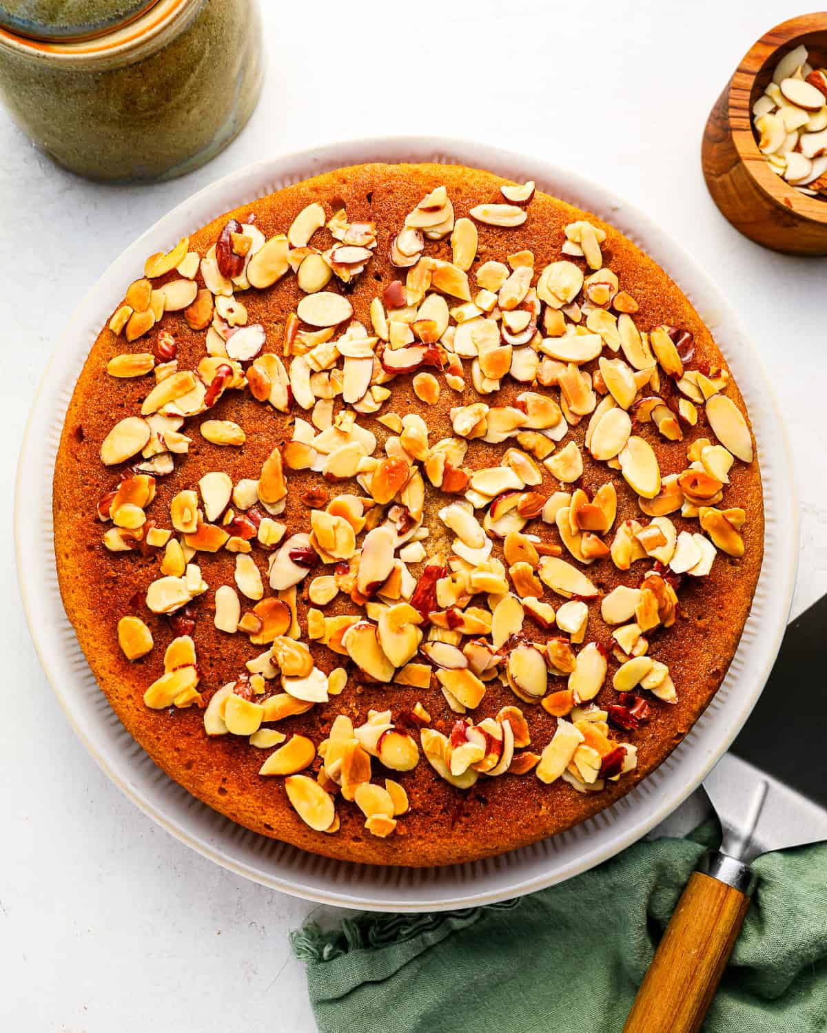 A whole honey cake topped with almonds.