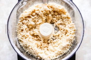 A food processor filled with a mixture of flour.