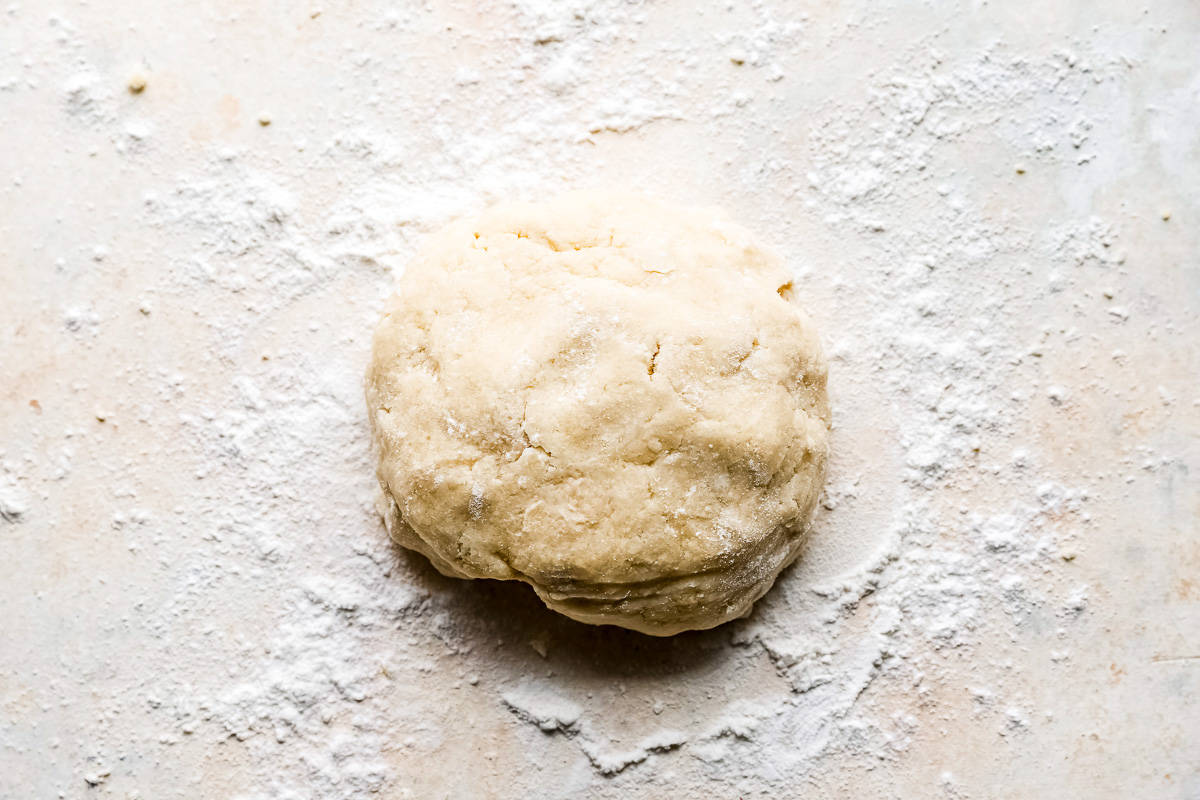 A ball of dough on a white surface.