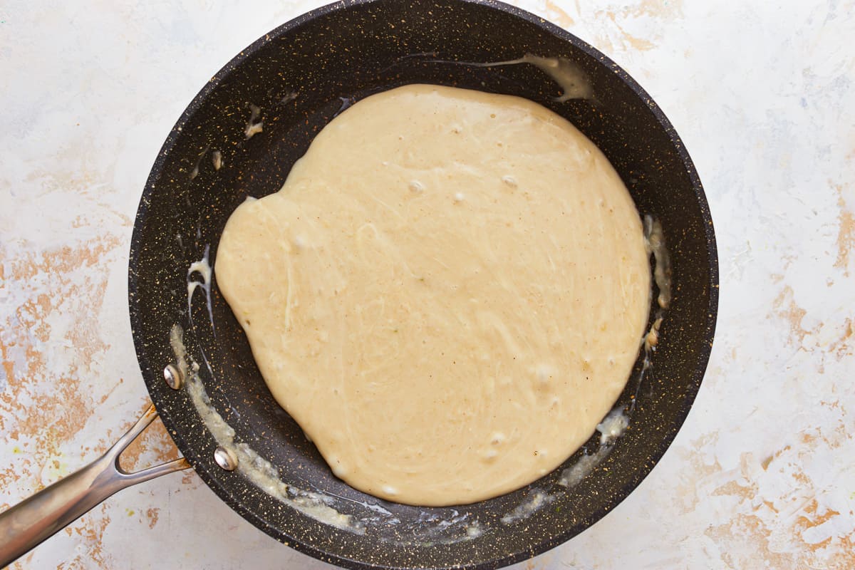 Thickened cheese sauce in a skillet.