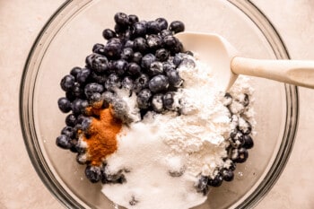 Ingredients for blueberry pancakes in a glass bowl.