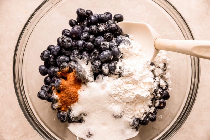 Ingredients for blueberry pancakes in a glass bowl.