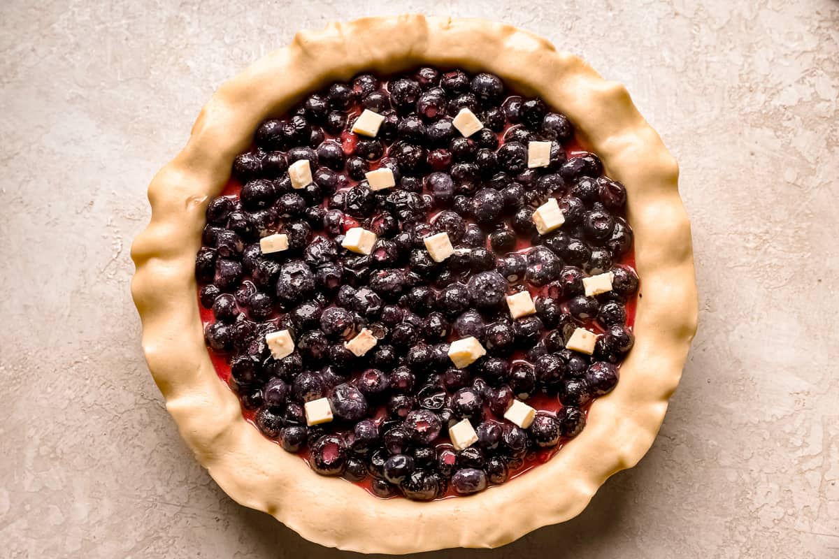 blueberry filling in a pie crust with butter.