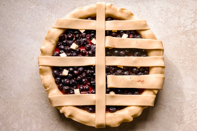 A pie with blueberries in a lattice pattern.