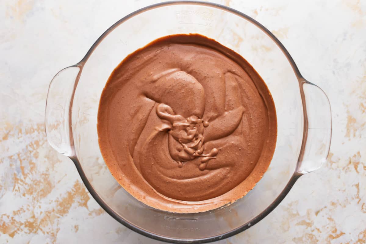 Chocolate cheesecake batter in a mixing bowl.