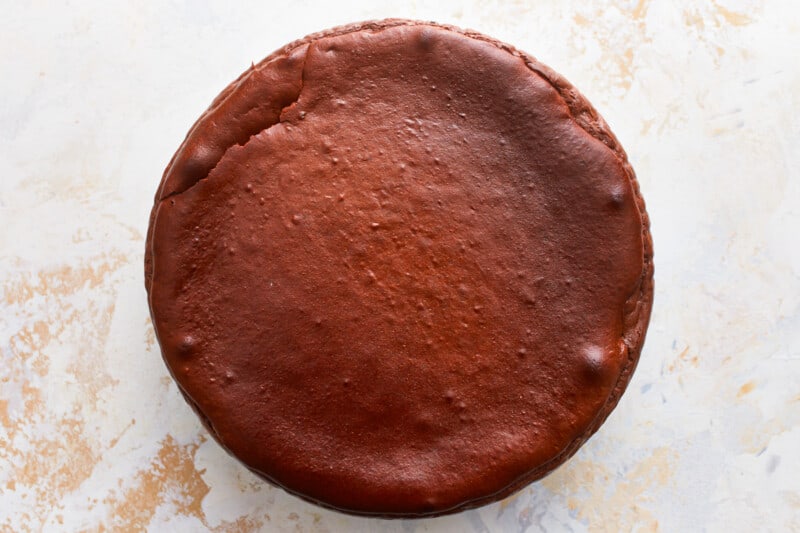 A chocolate cheesecake on a white surface.