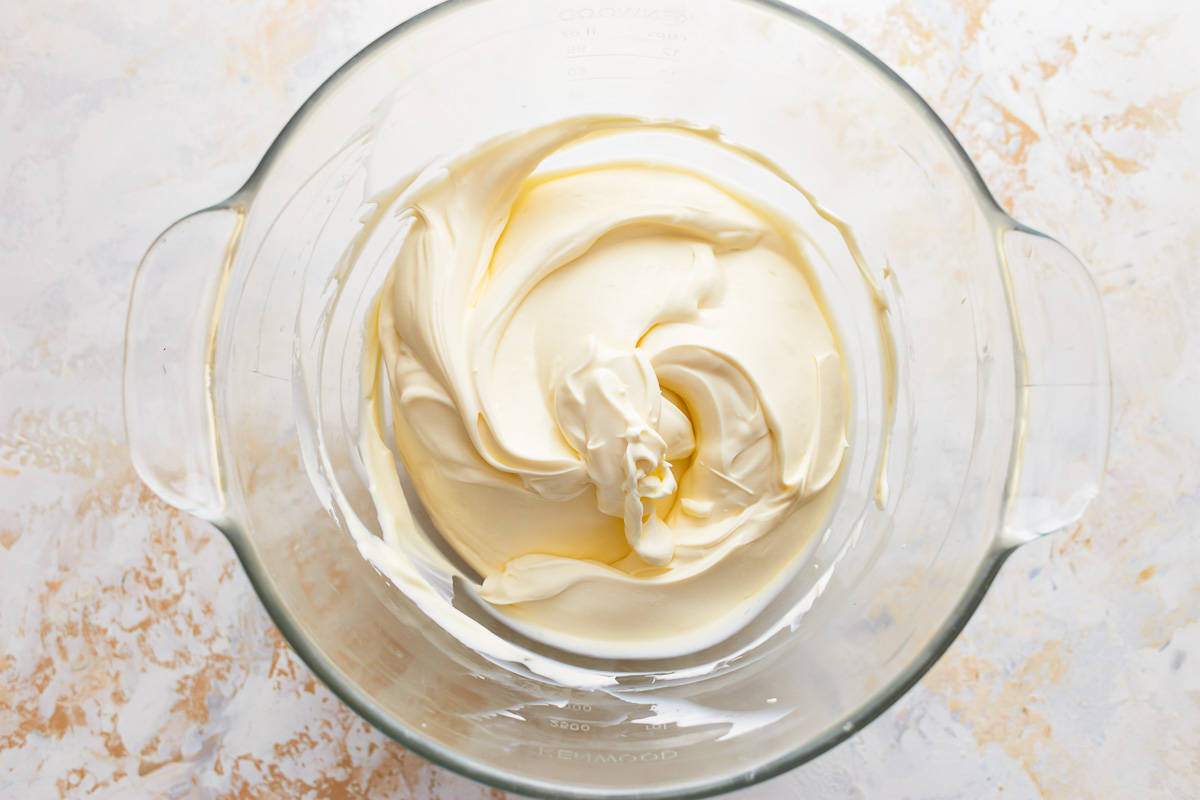 Cream cheese and butter creamed together in a mixing bowl.