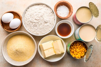 A bowl of flour, corn, eggs and other cornbread ingredients.