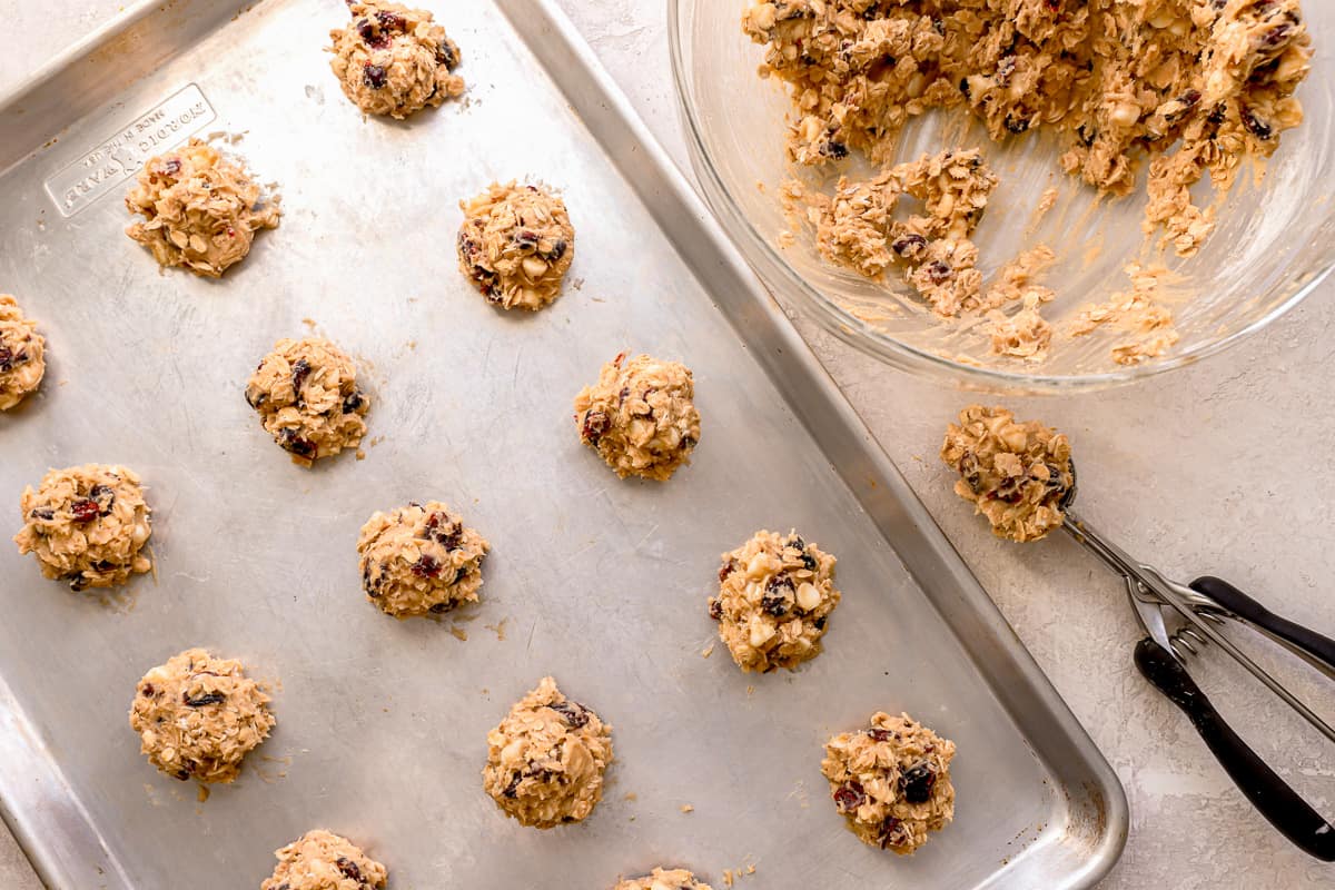 Balls of cookie dough arranged on a baking sheet.