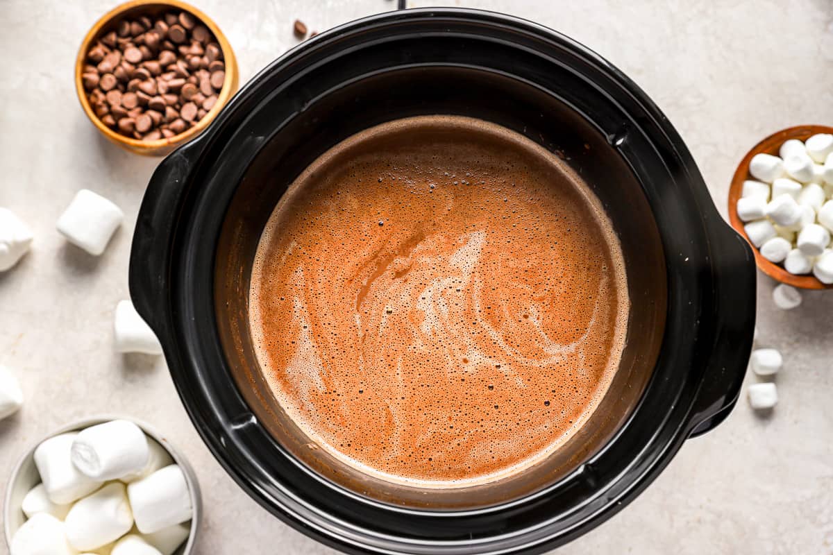 Hot chocolate mixture cooking in a slow cooker.