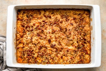 A casserole dish filled with pecans and oats.