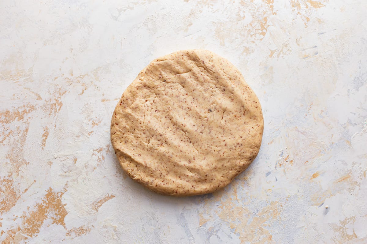 A piece of dough flattened into a disc shape.