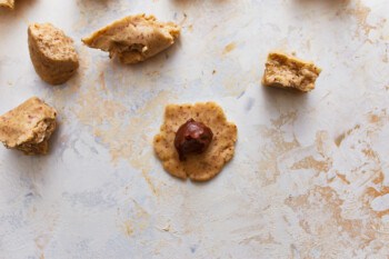 Ball of nutella placed at the center of a piece of cookie dough.