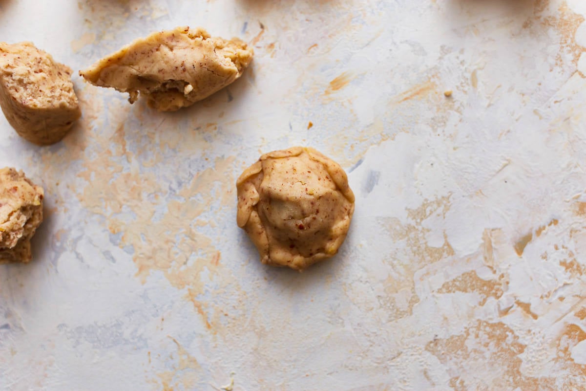 Ball of Nutella fully wrapped in pieces of cookie dough.