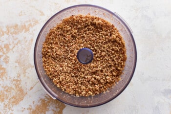 Finely chopped pecans in a food processor.